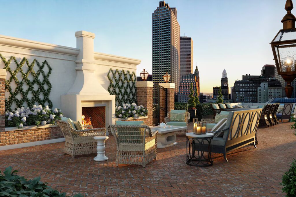 Golden hour light washing over the terrace of the Ritz-Carlton New Orleans with cityscape and wedding tablescape.