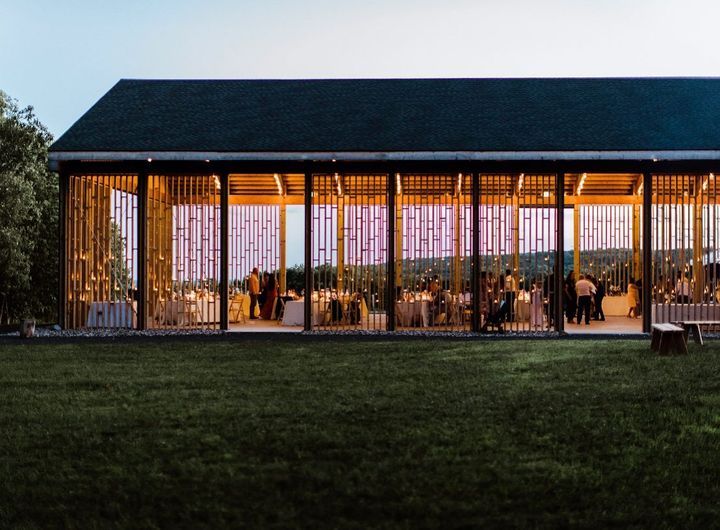Evening wedding reception at Gather Greene, an editorial Upstate New York wedding venue with open-air pavilion architecture and ambient lighting.