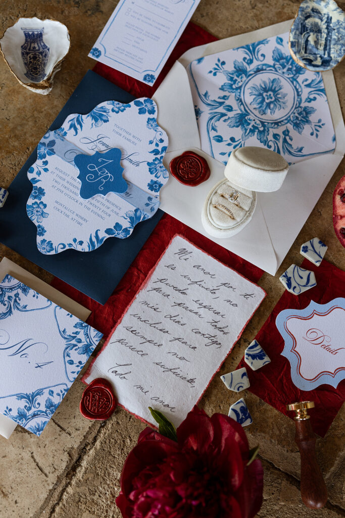Luxury wedding stationery flatlay in blue, red, and white tones — illustrating Fox & Quinn’s approach to contrast and composition in wedding planning and design.