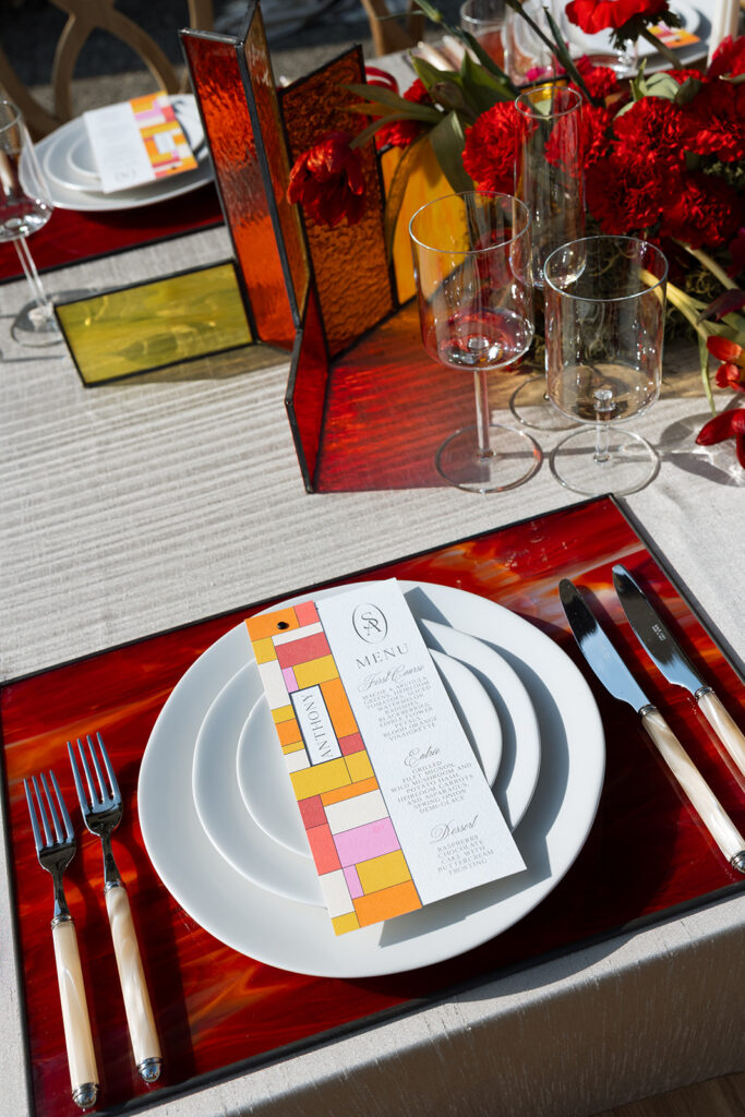 Artful wedding place setting with geometric menu and glass panels — illustrating Fox & Quinn’s focus on texture, material, and thoughtful detail in wedding planning.