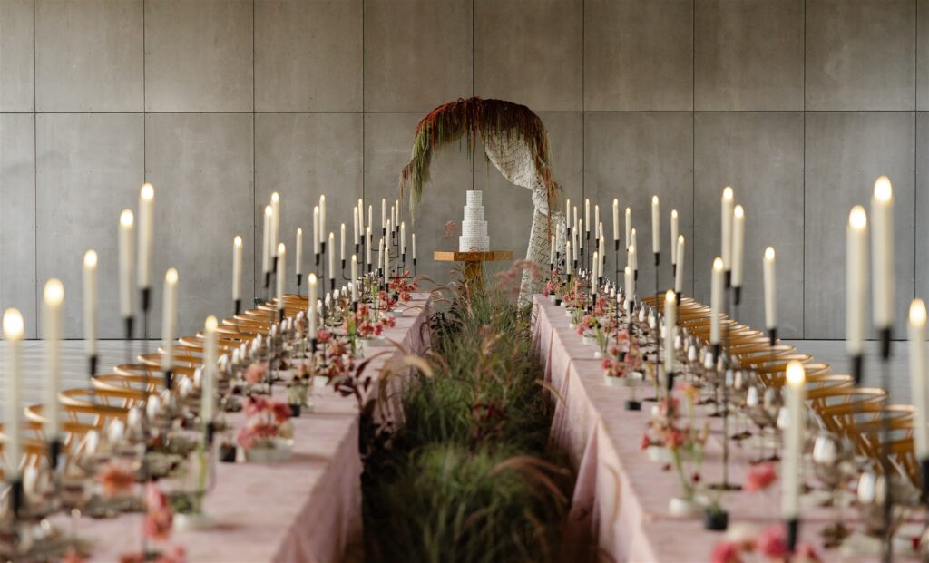 Editorial wedding reception design at Gather Greene, featuring long tables, candlelight, and sculptural florals — illustrating space and flow in modern wedding planning.