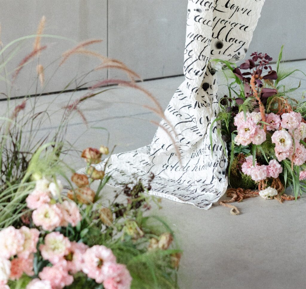 Floral arrangement with calligraphy fabric