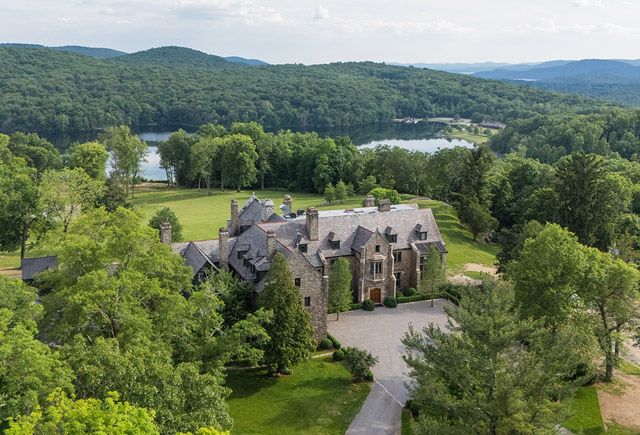 Aerial view of The Ranch Hudson Valley, a luxury Upstate New York wedding venue surrounded by forest and overlooking a private lake.