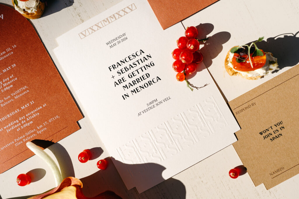 Embossed wedding invitation suite for a Vestige Son Vell wedding, styled with red currants and canapés, Menorca
