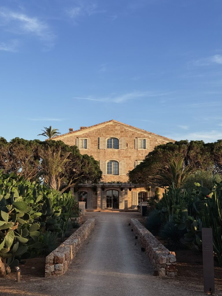 The sandstone manor at Vestige Son Vell framed by cactus gardens at golden hour, Menorca