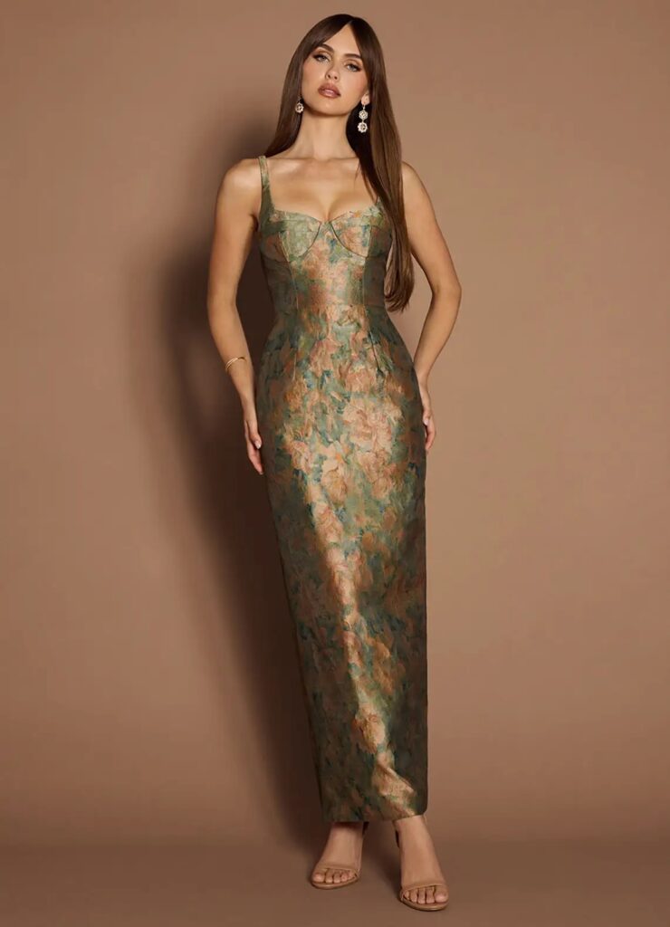 Elegant jacquard evening gown in earthy green and copper tones with a fitted bodice and painterly floral texture—evoking the richness of a blooming garden at dusk.
